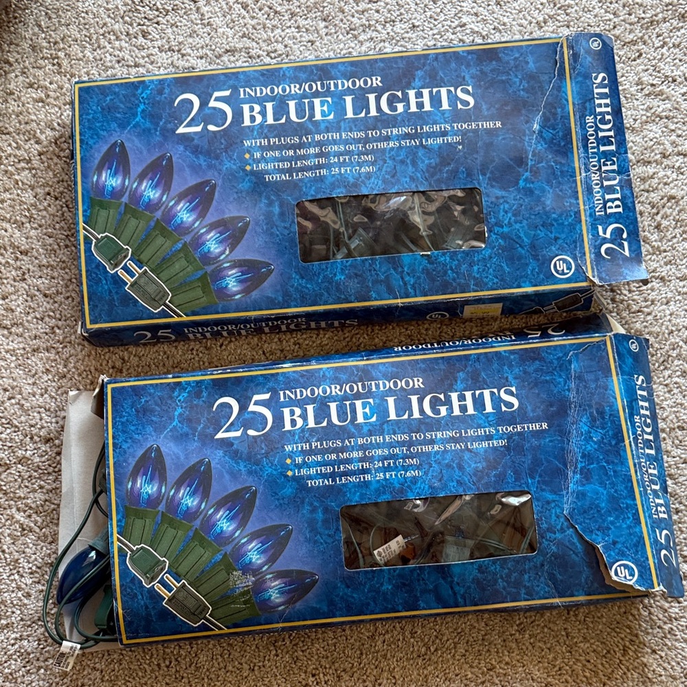 25 Indoor/Outdoor Blue String Lights Set of 2 boxes. One string has 4 red bulbs.